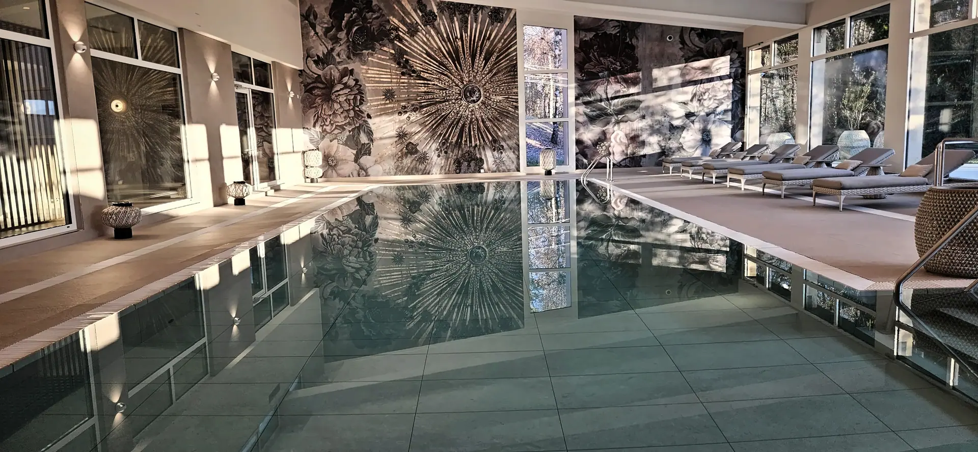 La piscine thérapeutique du Domaine de la Gracieuse, avec sa grande fresque florale dorée qui se reflète dans l’eau